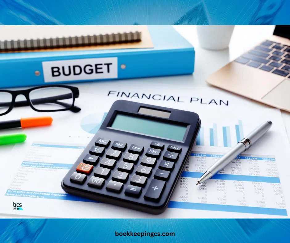 Budget binder, financial plan and calculator on a desk