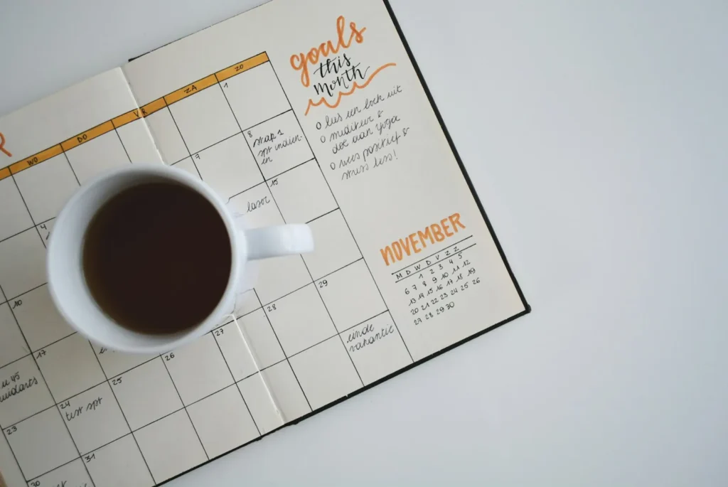 Coffee mug on a monthly planner calendar