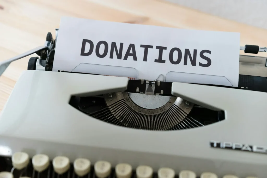 Typewriter with a sheet of paper that reads Donations