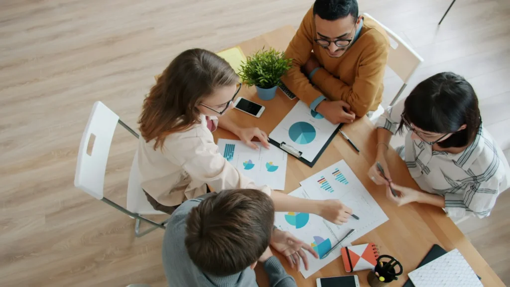 Diverse team reviewing charts together at a table